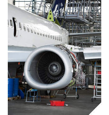 Image of an airplane undergoing maintenance in a hanger