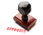 Image of rubber stamp with the text “Approved” on it